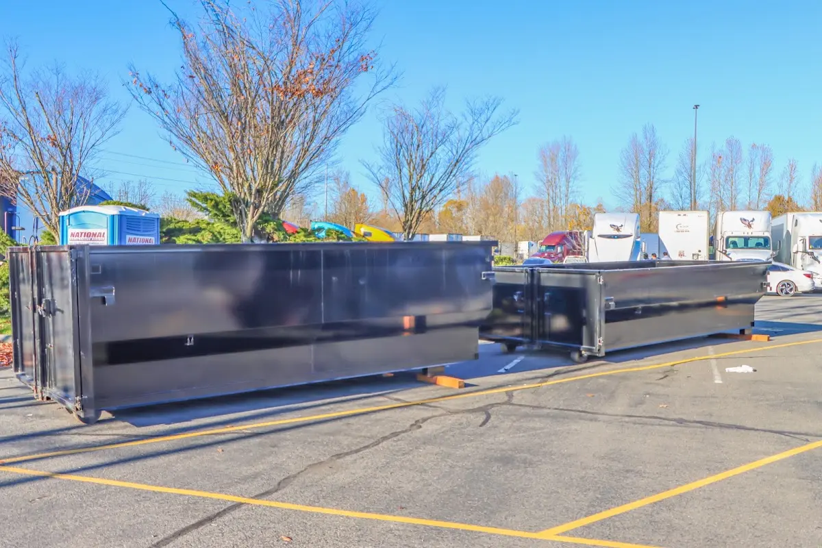 Professional dumpster rental service with roll-off container on residential driveway in Hales Corners